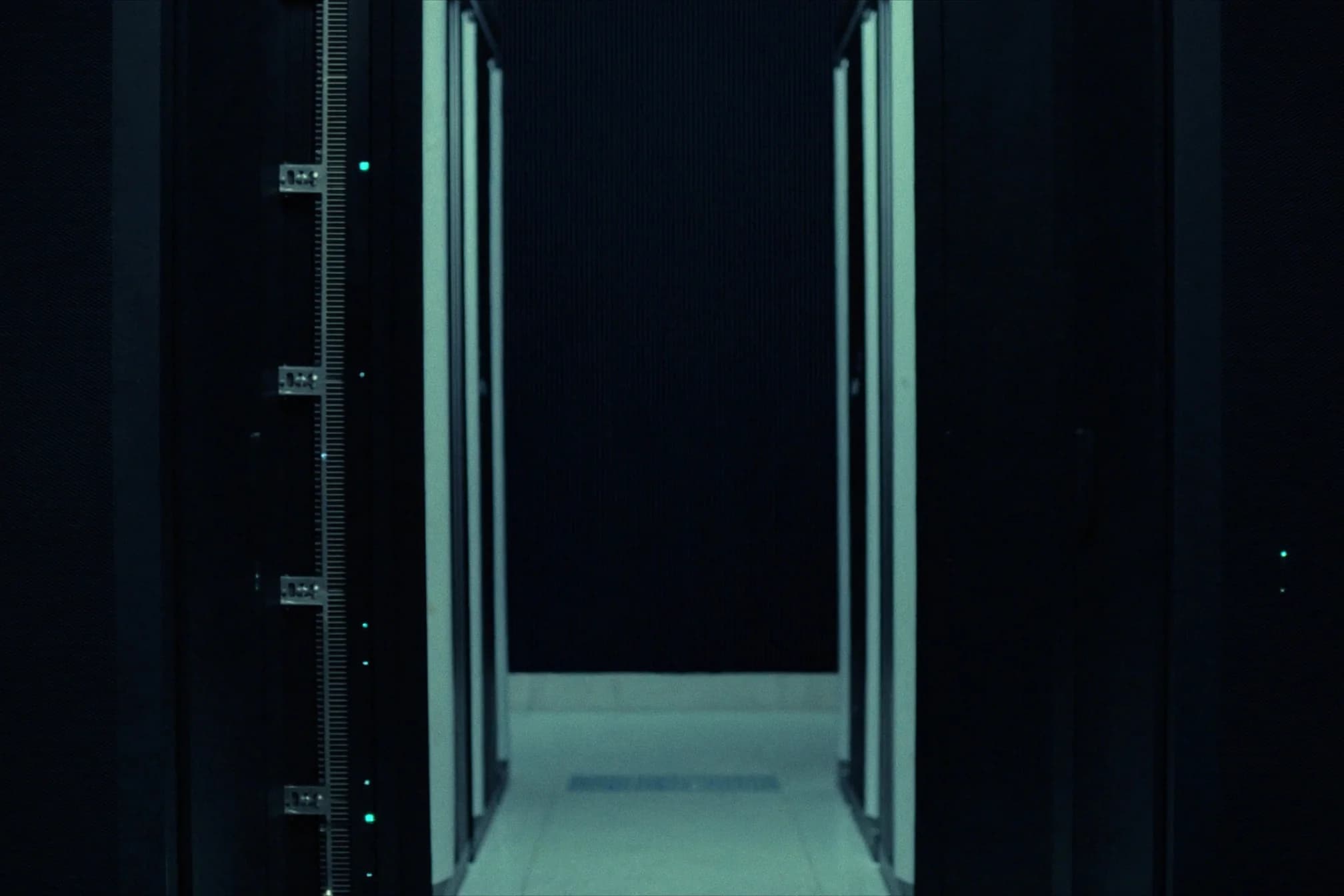 Data-centre corridor with teal-lit server racks